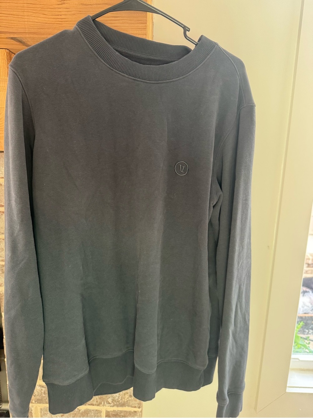 Vuori Men's Cypress Crewneck Sweatshirt featuring a washed grey color and a smal